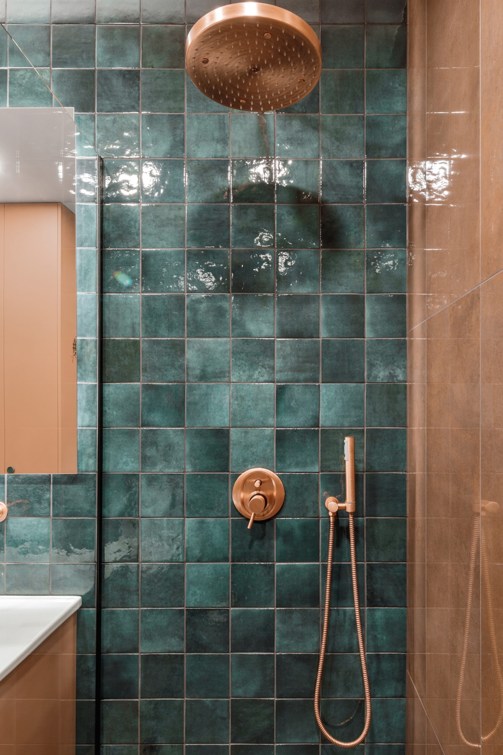 Minimalistic bathroom interior design in green and terracotta shades.